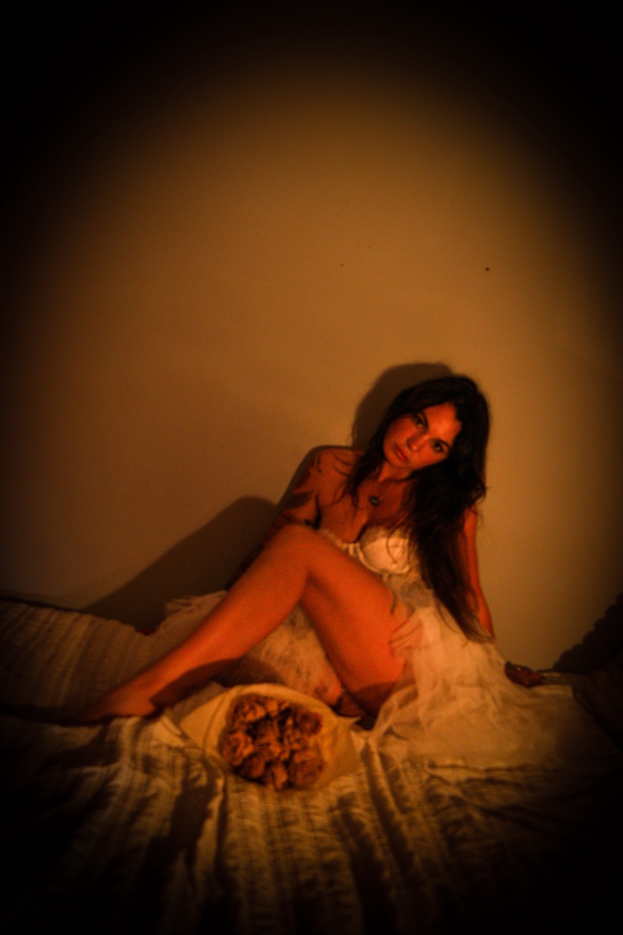 Candlelit portrait seated on a bed